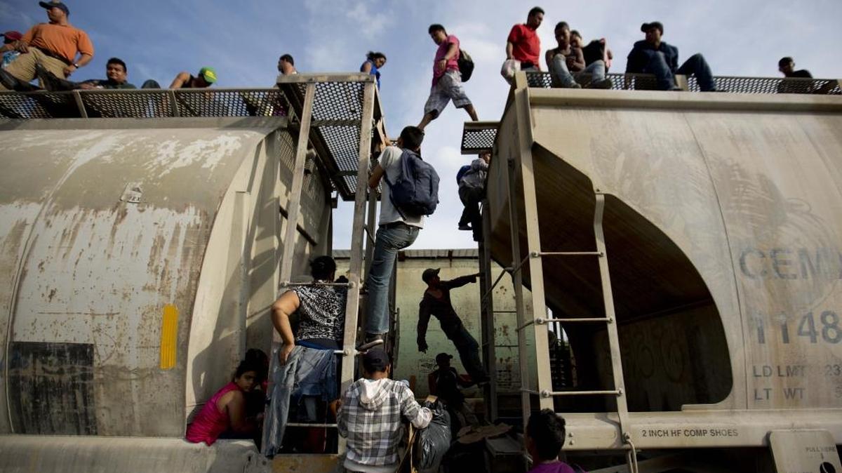 Central American migrants climb on a north bound train during their journey toward the U.S.-Mexico border, in Ixtepec, Mexico. The number of unaccompanied minors detained on the U.S. border has more than tripled since 2011. Children are also widely believed to be crossing with their parents in rising numbers. (AP Photo/Eduardo Verdugo)