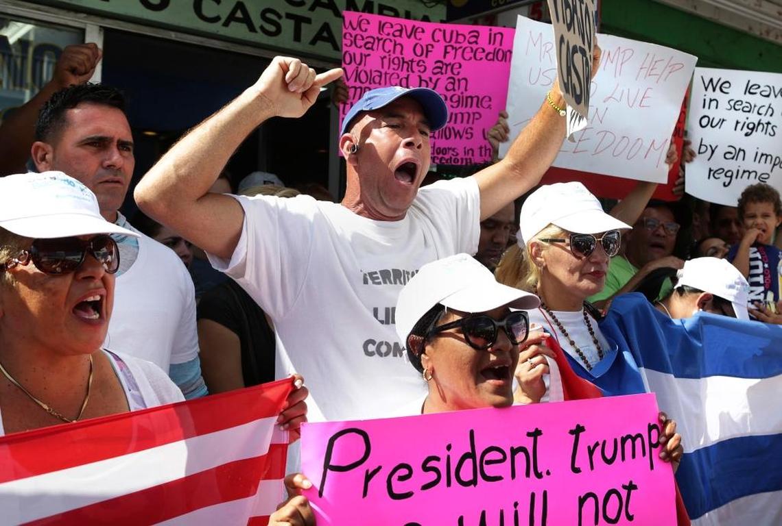 A Cuban man yells surrounded by other Cubans stranded in Nuevo Laredo, Mexico as they hold a rally and march from Plaza Juarez to the International Bridge.