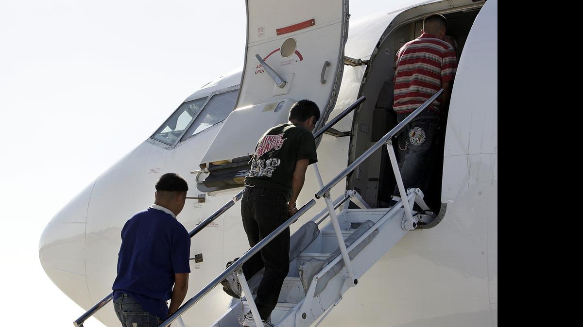 
A group of Mexican immigrants boards a plane at Miami International Airport (MIA) for deportation to the border with Mexico, in 2007, for being undocumented or for having been criminally convicted criminals. A total of 121 men and one woman were deported on that flight.
