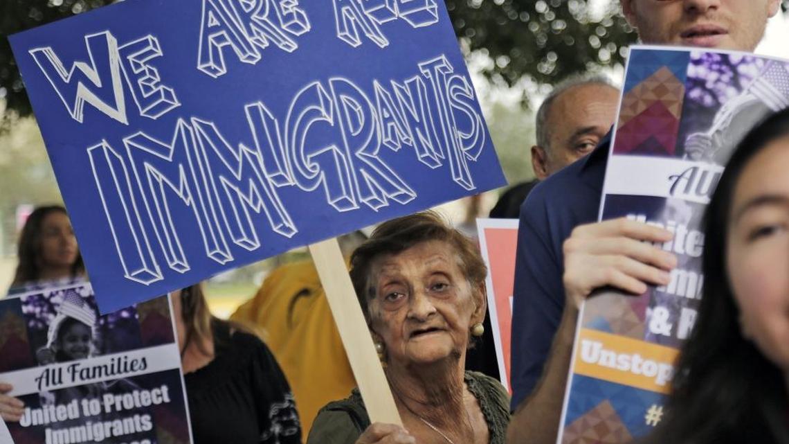 Sunrise resident Teresa Sarmiento, center, joins immigrant rights activists at a rally outside the Broward Transitional Center, a detention facility for undocumented immigrants.