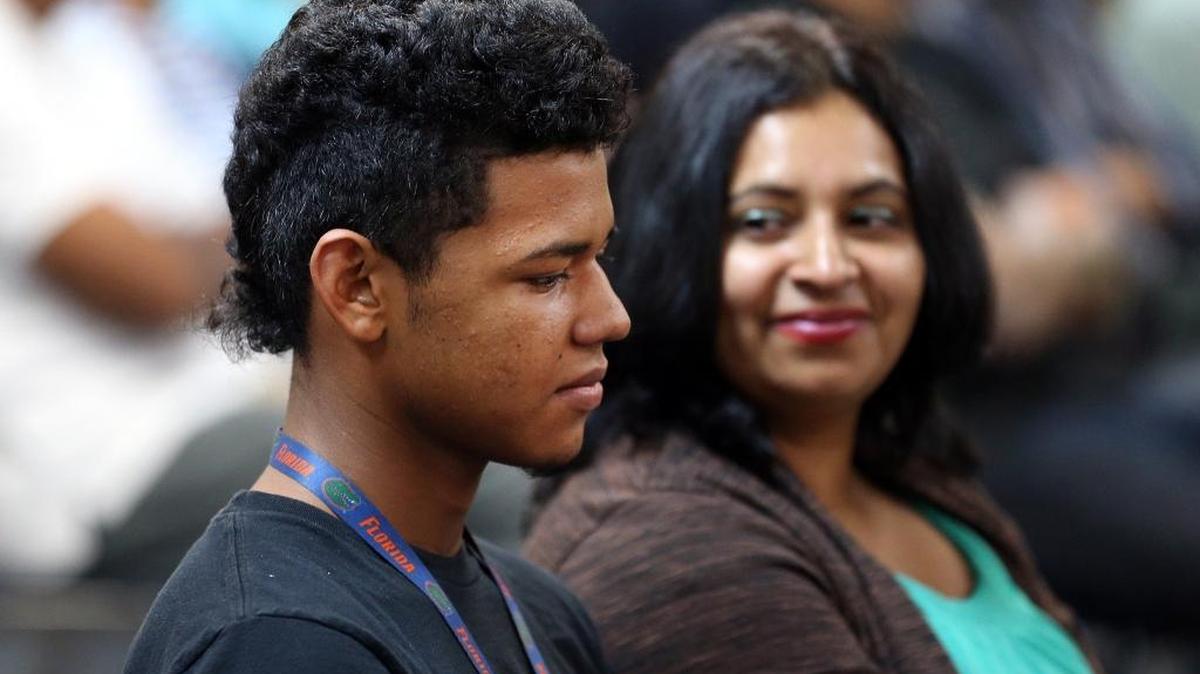 Mirta looks over at her son Daniel, 15, during a recent Saturday night service at the Amor Viviente evangelical church in North Lauderdale. The family is from Tegucigalpa, Honduras.