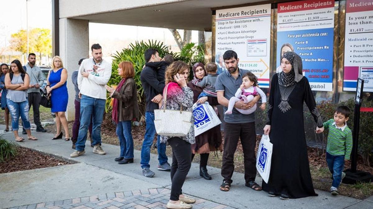The Alsaloum family waits in line at a social security office in Tampa on Feb. 2, 2017, with case worker Rana Al Sarraf of Coptic Orthodox Charities, Inc. Al Sarraf plays a crucial role in assisting refugee families with getting their lives started in the United States. Florida lawmakers are considering withdrawing any state assistance in a federal program that resettled refugees in Florida. Last year, 3,272 refugees resettled in Florida.