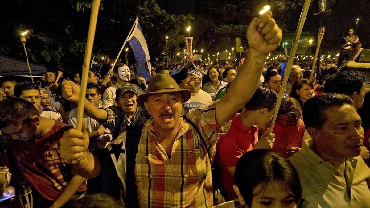 
A man joins an anti-corruption protest through the streets of Tegucigalpa, Honduras,  which was sparked by a social media campaign by young activists. Hondurans aren't prone to dramatic civic action, but this has been a year of loud and angry torchlight marches as the impoverished Central American country wrestles with perhaps the worst government corruption scandal in its history.
