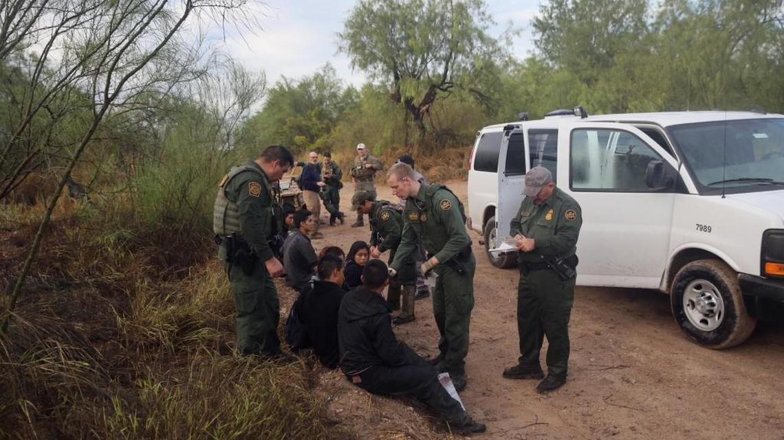 Detained immigrants are questioned after being captured by U.S. Border Patrol agents on August 16, 2016 in Roma, Texas.