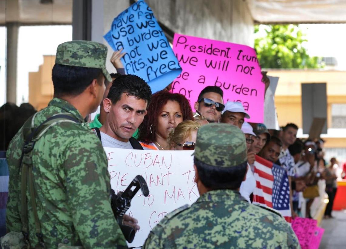 Cuban immigrant Reinier Aguila Esquivel talks with a Mexican soldier as he and other Cubans stranded in Nuevo Laredo, Mexico attempt to pass to the international bridge following a rally and march from Plaza Juarez to the International Bridge.