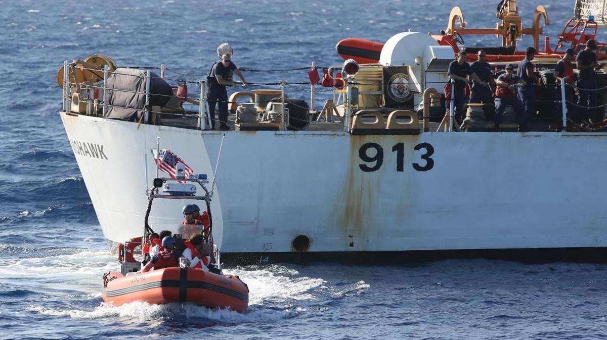 In this file photo taken in the Florida Straits on May 17, 2015, members of the U.S. Coast Guard cutter Charles David Jr, foreground, leave the USCG cutter Mohawk with six Cuban migrants.