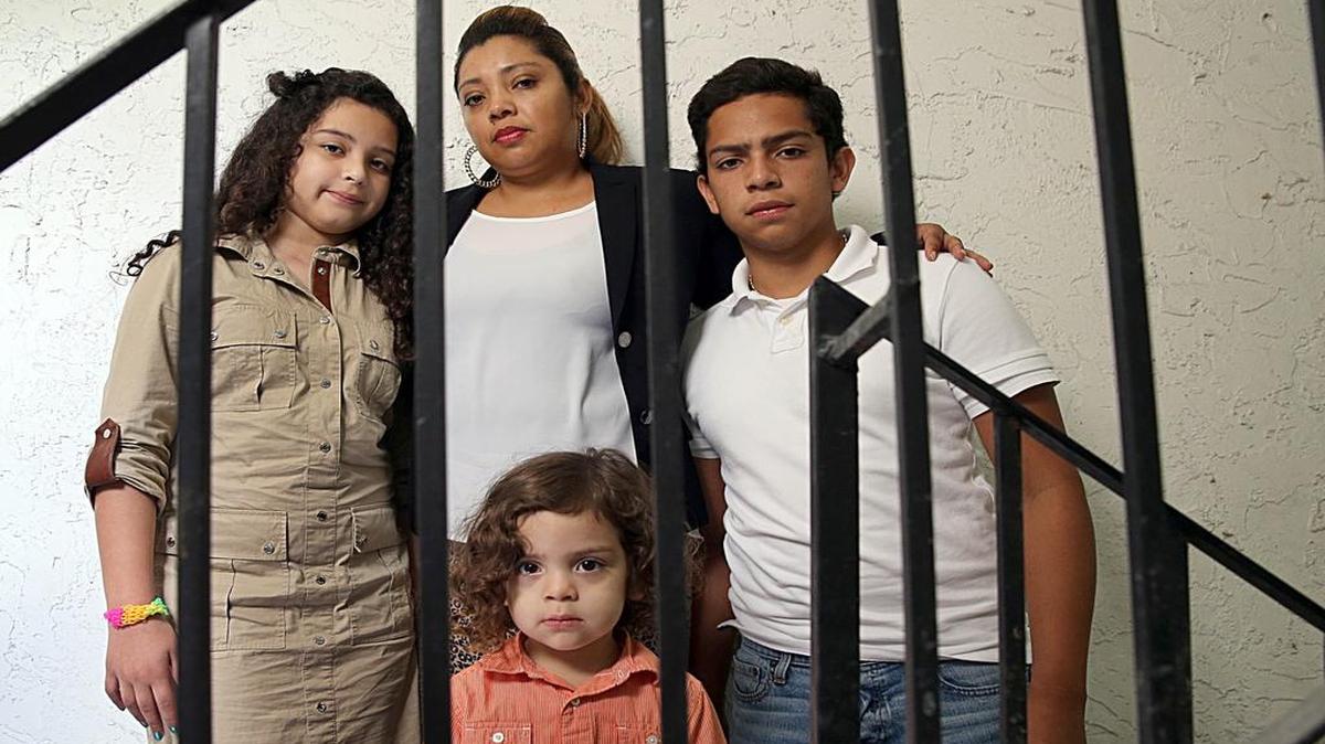 
Undocumented immigrant from Honduras, Karla Hernandez poses May 16, 2015 in Miami with her children, from left: Karolay; Mariano; and Carlos Mario. Hernandez is worried because her husband Mario Alcerro is incarcerated for having returned to the United States after being deported to Honduras. 
