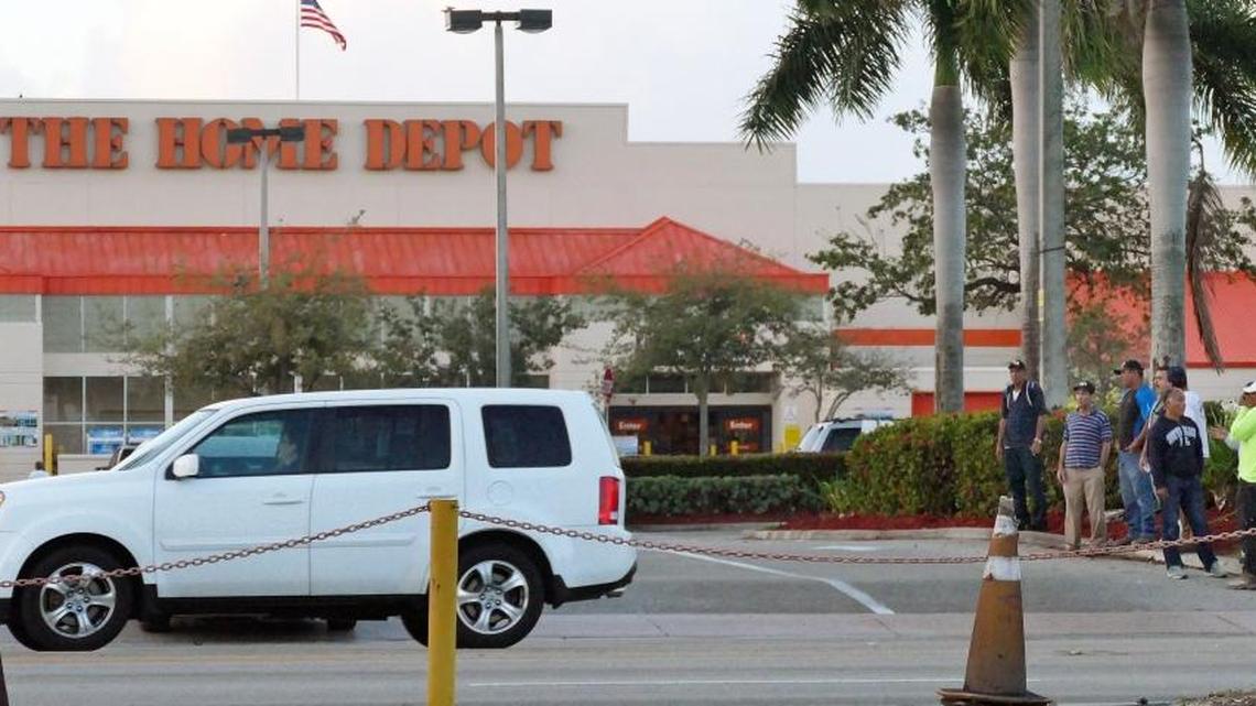 Day laborers, some of whom are undocumented immigrants looking to work, patiently wait for jobs offered by contractors coming to Home Depot to pick up workers early Tuesday, Feb. 28, 2017.