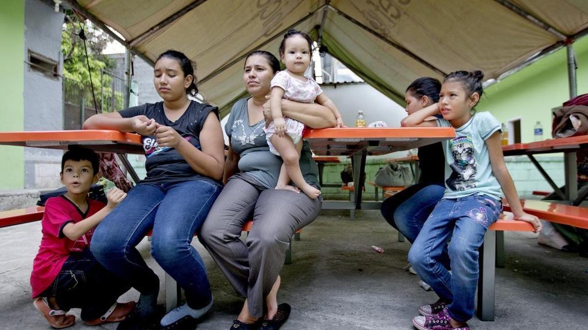 
Marinelis Sabillón, 33, holds her 7-month-old daughter Kendy Julieth Briones Sabillón after she and her husband Menelio Briones and their five children arrived at El Edén center in San Pedro Sula, Honduras. El Edén receives migrants who are bused back into Honduras after being intercepted in Mexico on their trek to the U.S.
