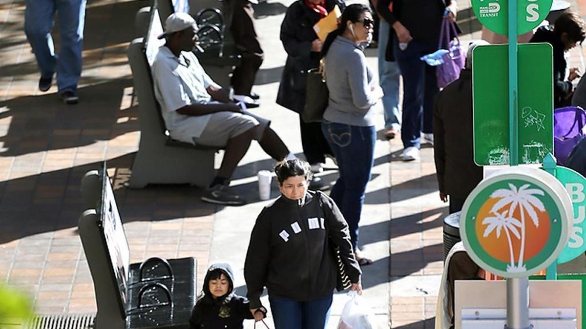 Commuters bundle up against an early morning chill in the 40s on Monday. The weather in South Florida is expected to be cool all week, with lows in the 40s and 50s and highs in the 60s. A warming trend is on the burner for Friday.