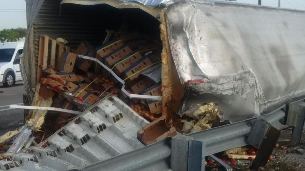 A tipped truck with produce spilling out is making a mess of Golden Glades traffic on Monday morning.