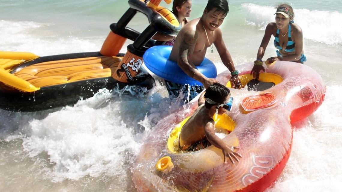 
Kaiden Chong, 5, lower right, with his parents Kendra Davis and Branden Chong of Homestead, and their neighbor, Arilyn Kirchhoff, 11, set out for the water Labor Day Weekend on Saturday, Aug. 30, 2014.
