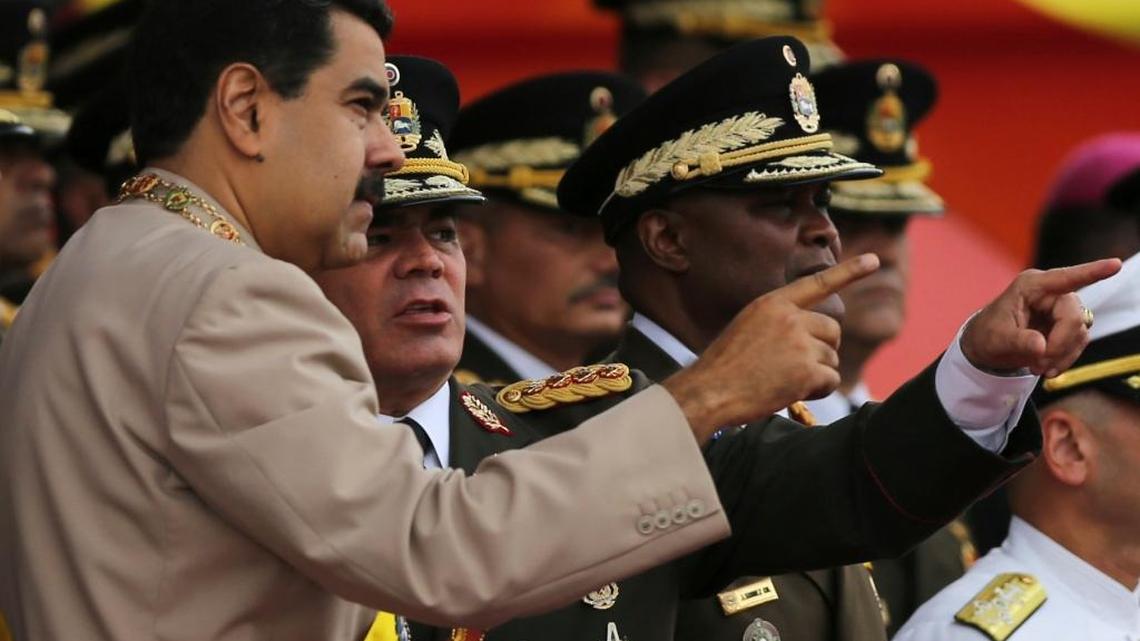 In this June 24, 2017 photo, Venezuela's President Nicolas Maduro, left, talks to his Defense Minister Vladimir Padrino Lopez during Army Day celebrations at Fuerte Tiuna, in Caracas, Venezuela.