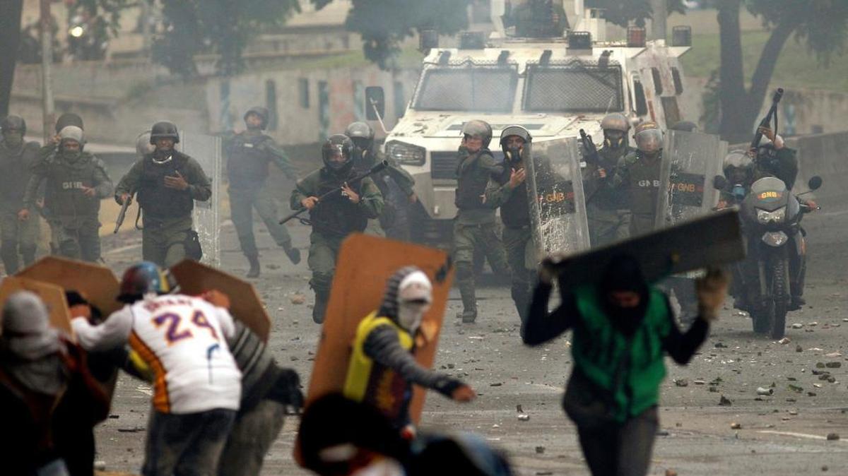 Bolivarian National Guards charge on anti-government demonstrators in Caracas, Venezuela, on July 28, 2017.