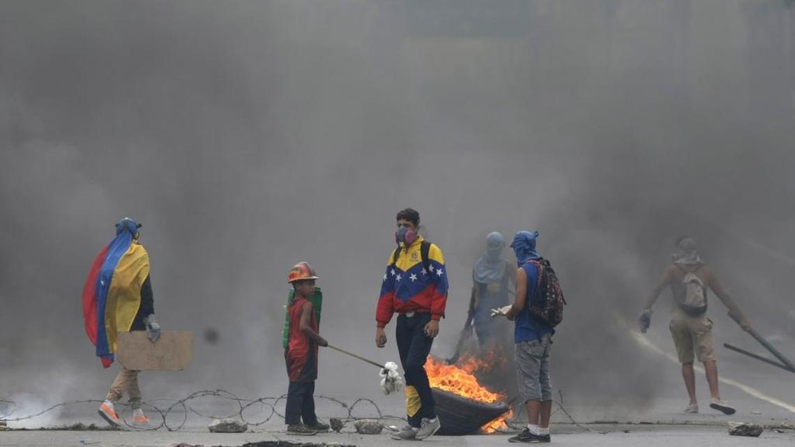 Demonstrators at a barricade on a highway during a national sit-in against President Nicolas Maduro, in Caracas, Venezuela, Monday, May 15, 2017. Opposition leaders are demanding immediate presidential elections.