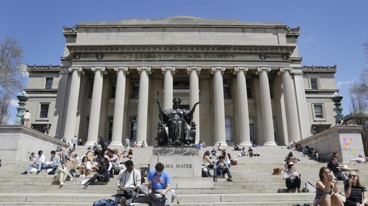 Students sit on the steps of Columbia University in New York. Though more U.S. students are studying in Latin America, fewer foreign students are coming to the United States.