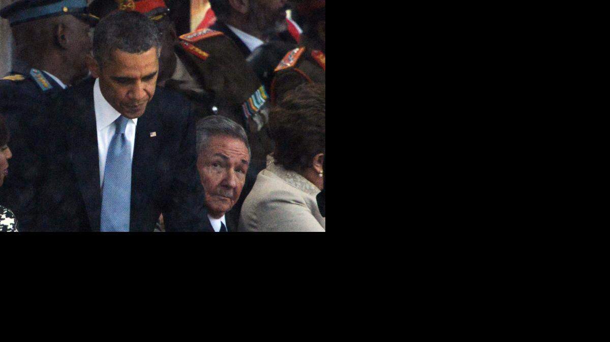 
A NEW DAY: Cuban leader Raúl Castro Ruz (R) looks at President Barack Obama (L) after his address during the memorial service of South African former president Nelson Mandela. Cuba and the U.S. last week announced plans to normalize relations. 
