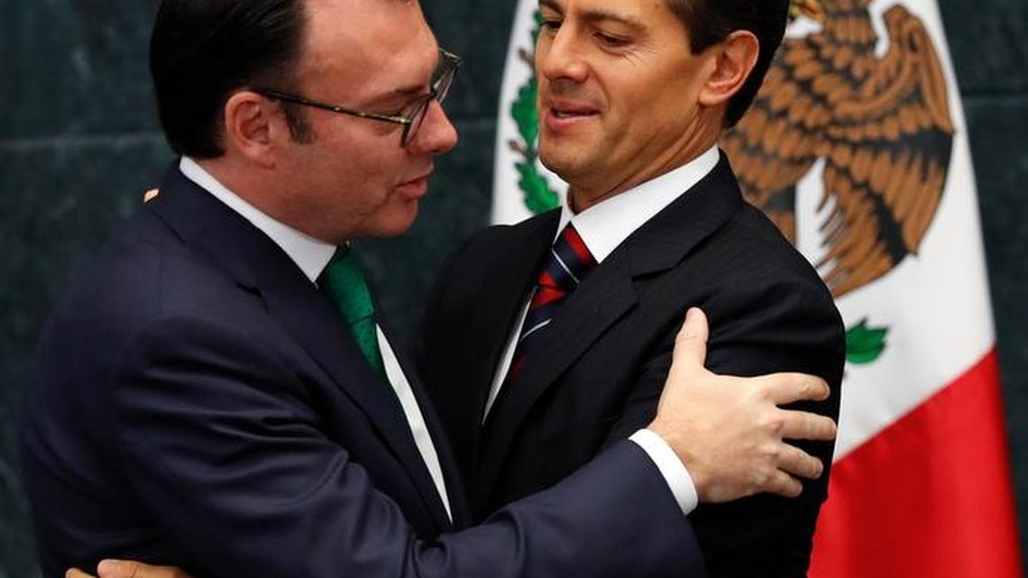 Mexico's President Enrique Pena Nieto embraces Finance Secretary Luis Videgaray after accepting Videgaray's resignation Sept. 7. The The Treasury Department gave no reason for the resignation, but it came in the wake of Pena Nieto's widely criticized meeting with the Republican presidential nominee Donald Trump.
