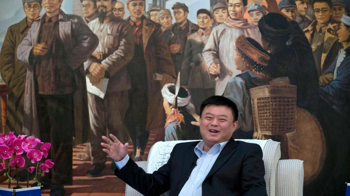 Wang Jing, founder and owner of the HKND Group, speaks during an interview in front of a painting featuring the late Communist leader Mao Zedong and his Red Army commanders in Beijing, China, Sept. 1, 2013. When Nicaraguan President Daniel Ortega granted the Chinese telecommunications executive exclusive rights to develop a $40 billion canal through Nicaragua and operate it for 100 years, his administration touted the CEO's record of success heading a wireless communications firm with projects in 20 countries.