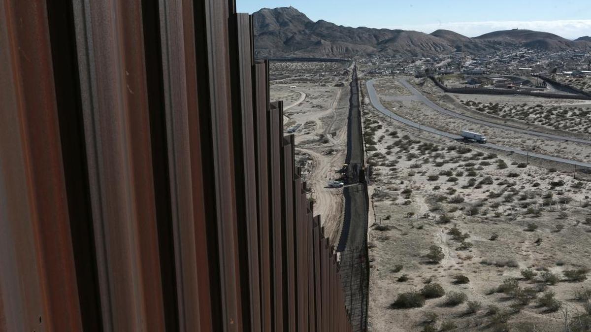 In this Jan. 25, 2017, file photo, a truck drives near the Mexico-US border fence, on the Mexican side, separating the towns of Anapra, Mexico and Sunland Park, New Mexico. White House budget documents show President Donald Trump wants billions of dollars to start building a wall at the Mexican border.