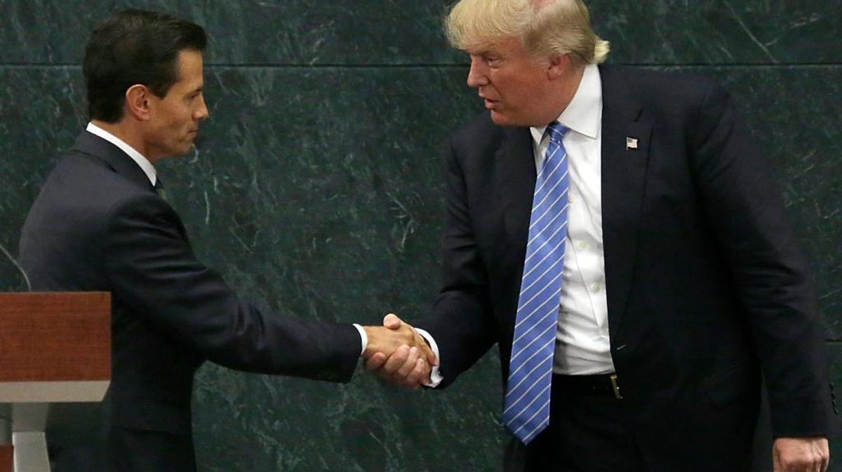 In this Aug. 31, 2016 photo, Mexico's President Enrique Pena Nieto, left, and Republican presidential nominee Donald Trump shake hands after a joint statement at the presidential official residence in Mexico City.
