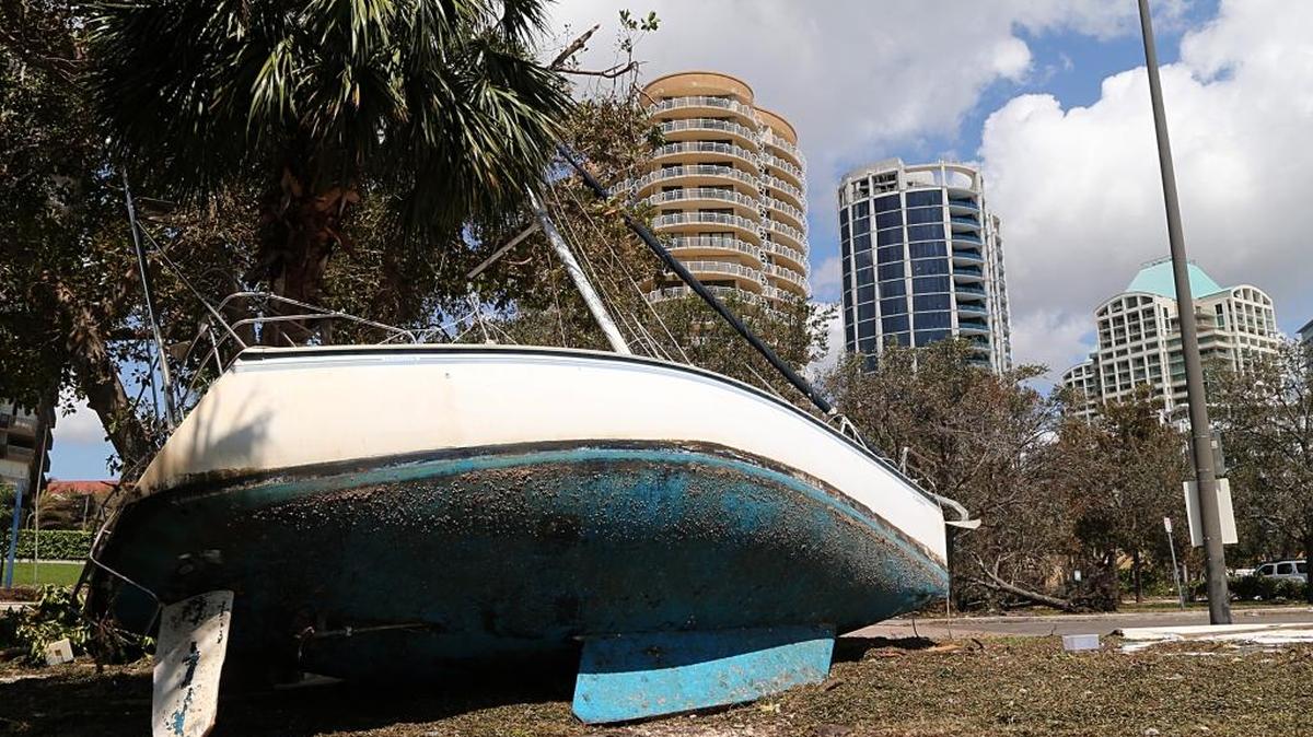 A damaged sailboat washed ashore in the Grove Key Marina parking lot in Miami, after Hurricane Irma hit South Florida.
