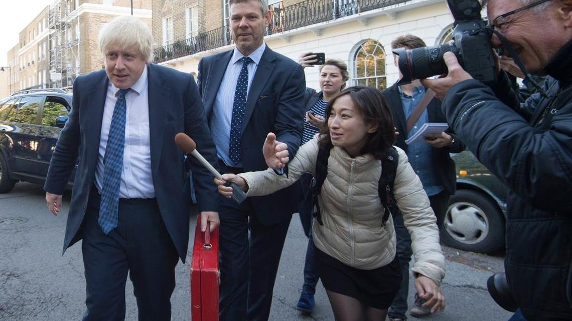 Newly appointed British Foreign Secretary Boris Johnson is pursued by members of the media as he leaves his home in north London, as new Prime Minister Theresa May prepared to put the finishing touches to her top team, Thursday July 14, 2016.