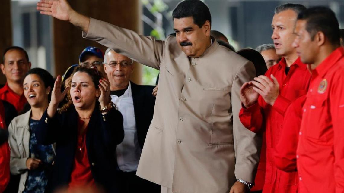 Venezuela's President Nicolas Maduro waves to supporters outside the National Electoral Council headquarters in Caracas, Venezuela, Wednesday, May 3, 2017. Maduro delivered a decree kicking off a process to rewrite the troubled national constitution.