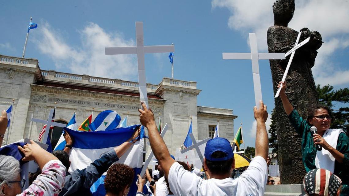 Nicaraguans bears crosses to protest violence in their country during a meeting of the OAS in Washington on June 4.