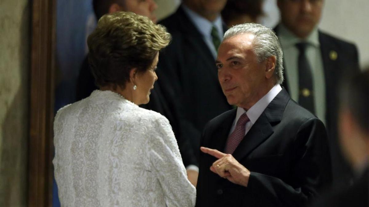 In this Oct. 2, 2015 file photo, Brazil’s President Dilma Rousseff and Vice President Michel Temer talk before announcing reforms at the Planalto Presidential Palace in Brasilia, Brazil.