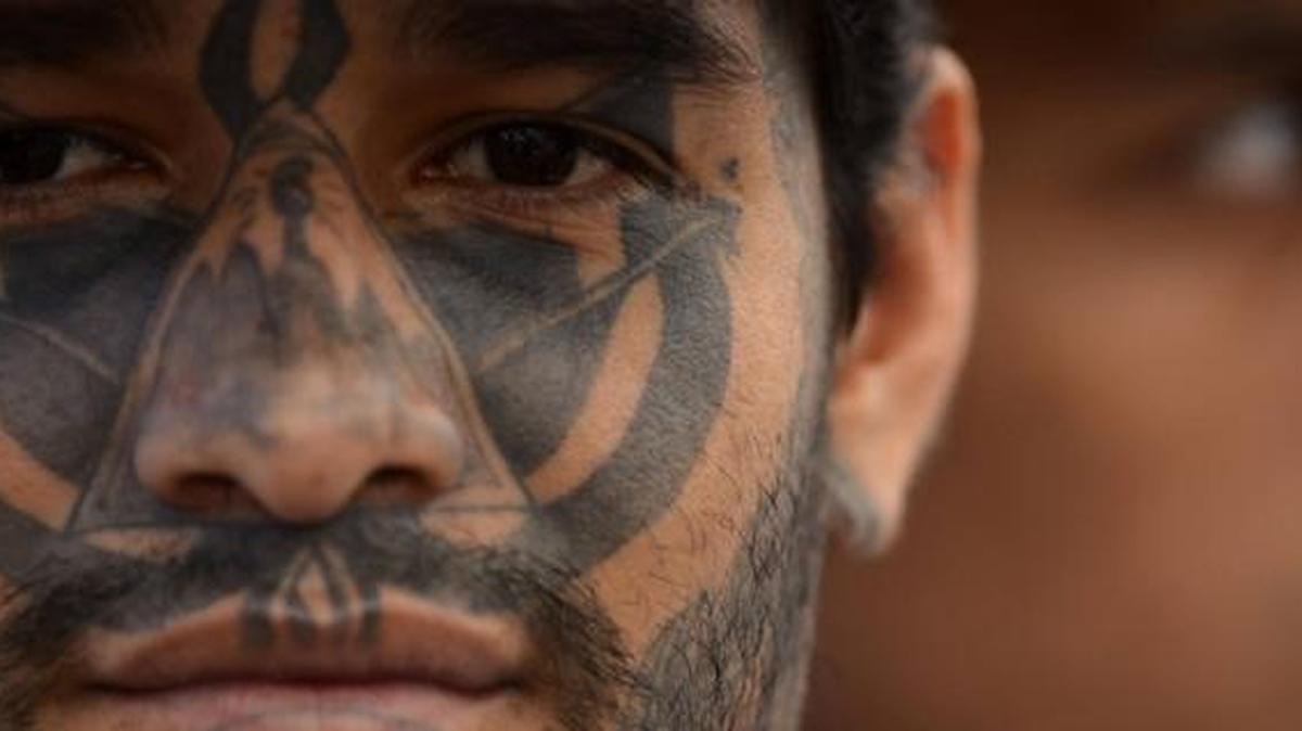 A member of one of El Salvador’s violent gangs has a tattooed face.