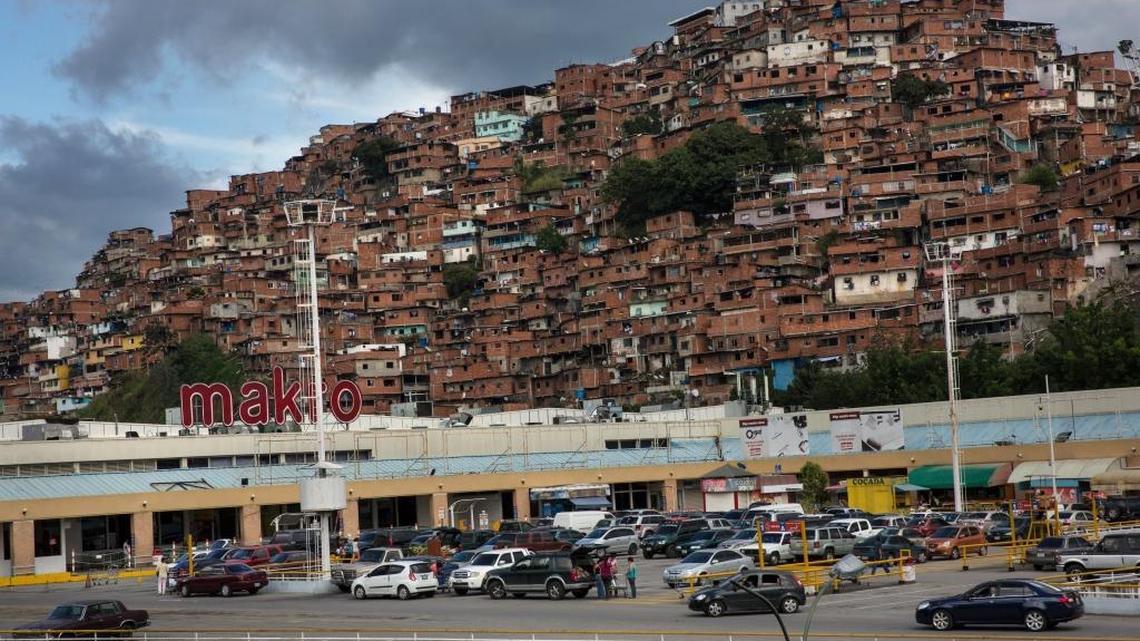 People load their supermarket shopping in their cars, in Caracas, Venezuela, Saturday, Oct. 28, 2017.