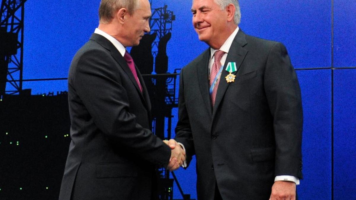 In this 2012 photo, Russian President Vladimir Putin presents ExxonMobil CEO Rex Tillerson with a Russian medal at an award ceremony of heads and employees of energy companies at the St. Petersburg economic forum in St. Petersburg, Russia.