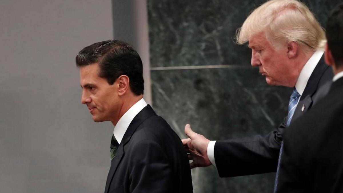 In this Aug. 31, 2016 file photo, then-Republican presidential nominee Donald Trump walks with Mexico President Enrique Pena Nieto at the end of their joint statement at Los Pinos, the presidential official residence, in Mexico City.