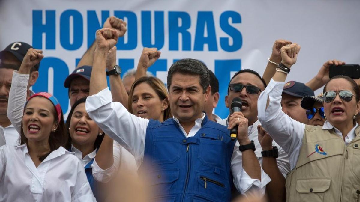 Honduran President Juan Orlando Hernandez raises his right fist as he speaks to supporters, in Tegucigalpa, Honduras, Thursday, Dec. 7, 2017. Eight Latin American governments on Wednesday applauded Honduras' willingness to recount disputed votes in the presidential elections, but questions remain about how thorough that recount will be.