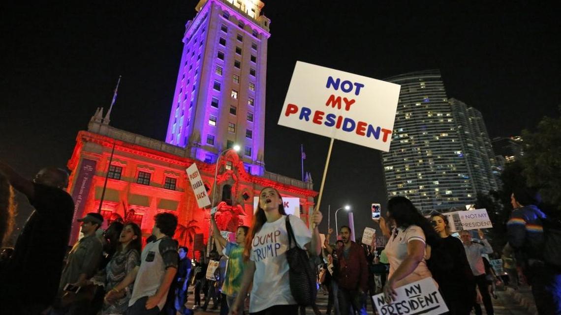 Demonstrators march along Biscayne Boulevard and Miami's Freedom Tower in protest against President elect Donald Trump on Friday, November 11, 2016