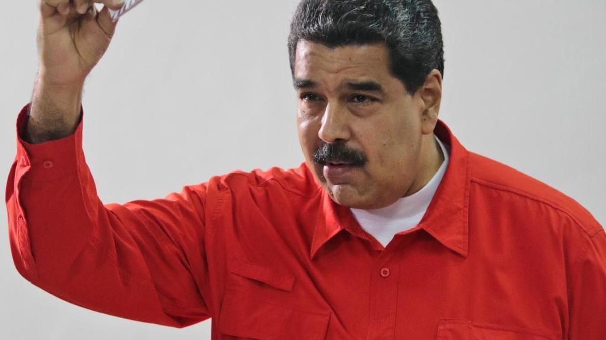In this photo released by the Venezuelan government, President Nicolás Maduro shows his ballot Sunday after casting a vote for a constitutional assembly in Caracas.
