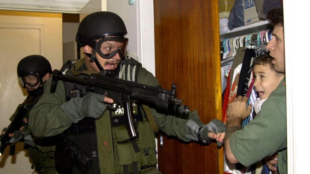 In this April 22, 2000, file photo, Elian Gonzalez is taken by U.S. law enforcement from the Little Havana home of uncle Lazaro Gonzalez.