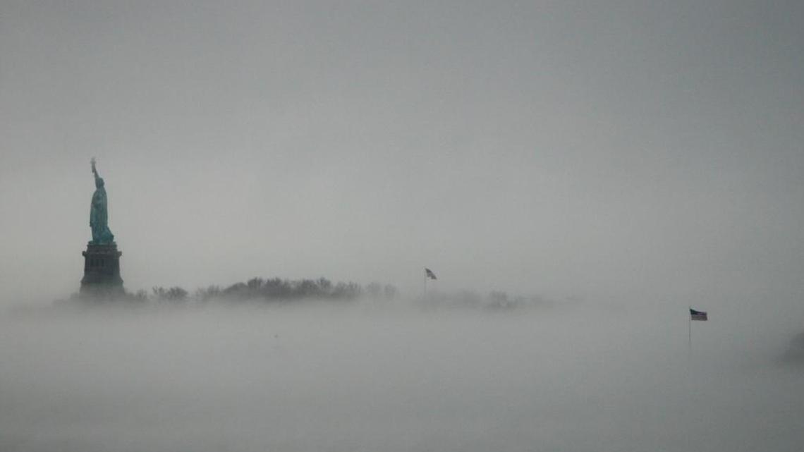 In this Jan. 11, 2014, file photo, the Statue of Liberty is surrounded by fog on Liberty Island in New York. Senior White House aide Stephen Miller told reporters Wednesday, Aug. 2, 2017, that the poem written by Emma Lazarus about the "huddled masses" is not part of the original Statue of Liberty. Miller says the Statue of Liberty is a "symbol of American liberty lighting the world" and suggested the statue had little to do with immigrants.