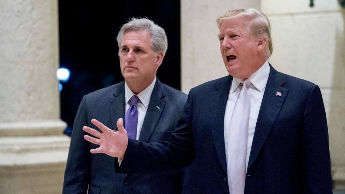 President Donald Trump, right, accompanied by House Majority Leader Kevin McCarthy, R-Calif., speaks to members of the media as they arrive for a dinner at Trump International Golf Club in in West Palm Beach, Fla., Sunday, Jan. 14, 2018.