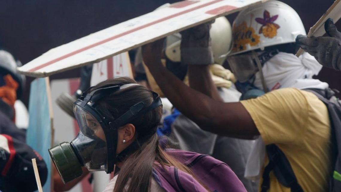 Anti-government protesters use homemade shields as they face off with security forces blocking their march from reaching the National Assembly in Caracas, Venezuela, Wednesday, May 3, 2017.