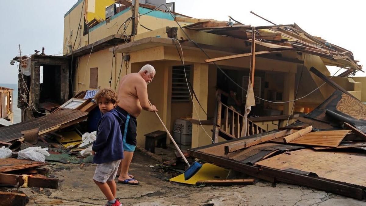 Residents of San Juan’s ‘La Perla’ neighborhood deal with the task of cleaning up after Hurricane Maria.