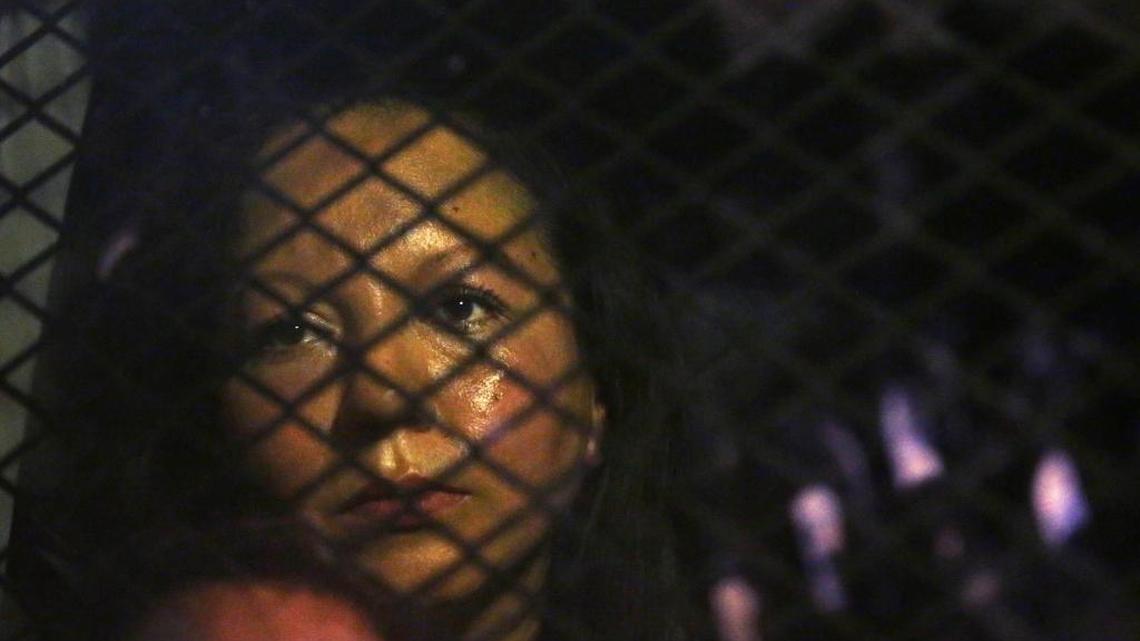 Guadalupe Garcia de Rayos is locked in a van that is stopped in the street by protesters outside the Immigration and Customs Enforcement facility Wednesday, Feb. 8, 2017, in Phoenix.