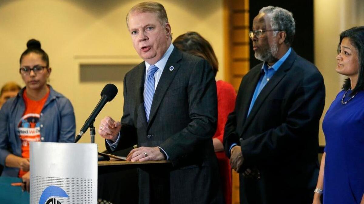 In this Nov. 9, 2016, file photo, Seattle Mayor Ed Murray, second left, speaks at a post-election event of elected officials and community leaders at City Hall in Seattle. On Wednesday, March 29, 2017, Murray announced that Seattle is suing President Donald Trump over his executive order that threatens to withhold federal funds from communities that refuse to cooperate with efforts to find and deport immigrants in the country illegally.