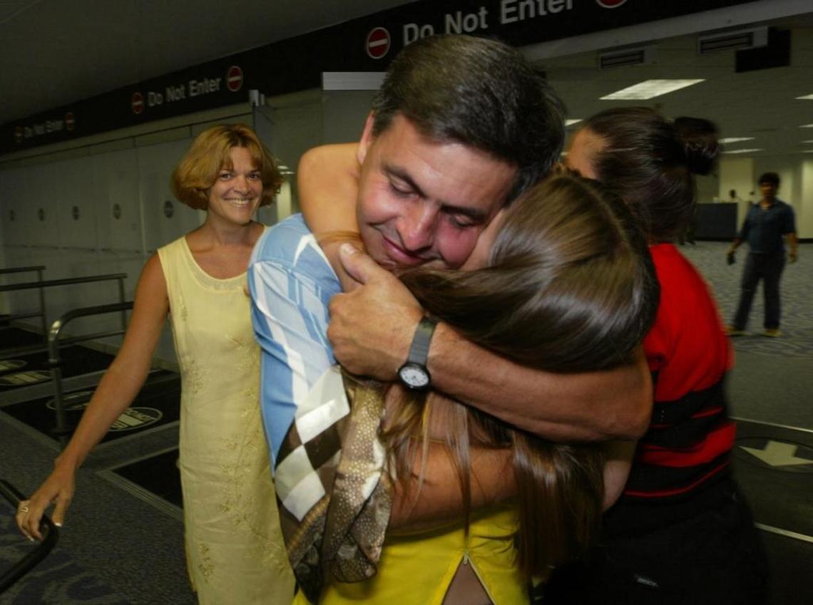 In 2002, Miami Gardens resident Raul Roger reunites at Miami International Airport with his daughter Liset Roger, right, and wife Nancy Perez, left, whom he had not seen since he left Cuba in 1994.