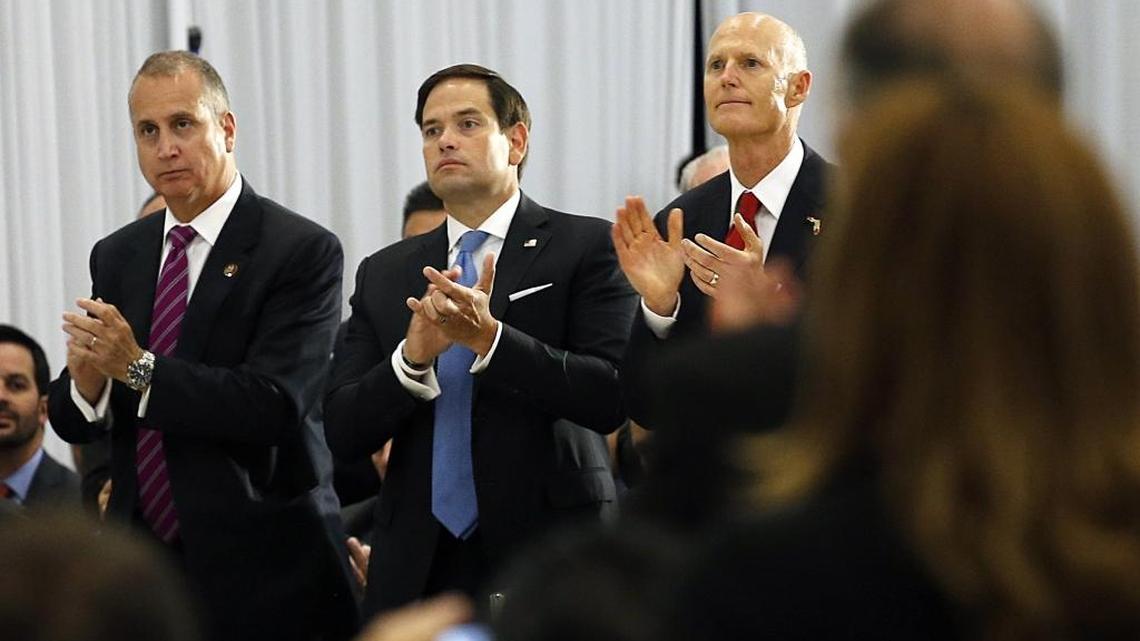 Congressman Mario Diaz-Balart, Sen. Marco Rubio and Gov. Rick Scott give Vice President Mike Pence a standing ovation as Pence spoke about Venezuela at Our Lady of Guadalupe Catholic Church in Doral on Wednesday.