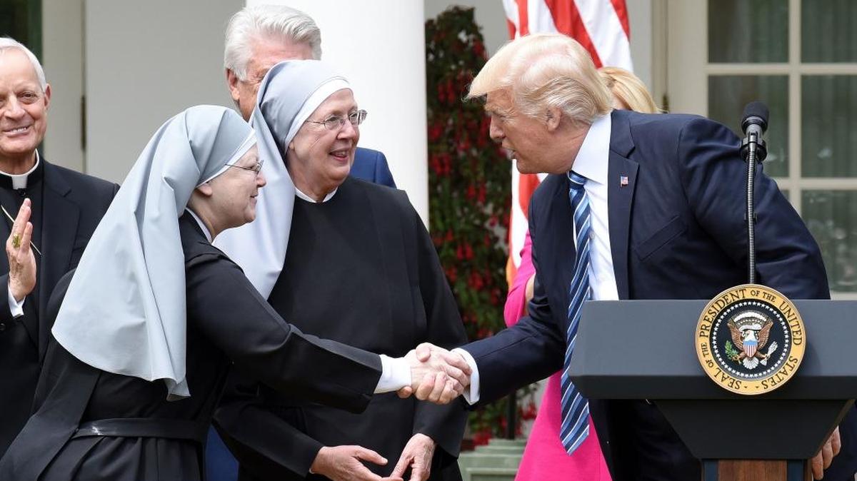 President Donald Trump greets the Little Sisters of the Poor before signing an executive order on Promoting Free Speech and Religious Liberty during a National Day of Prayer Event on May 4, 2017.