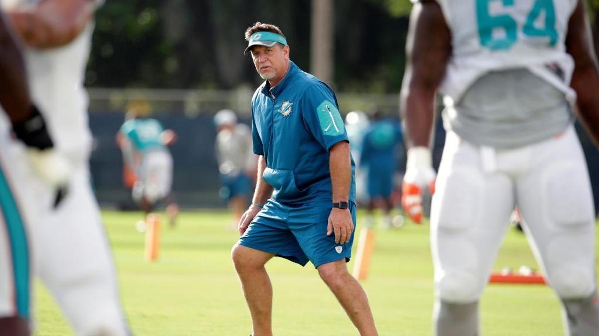 In this Aug. 16, 2016, file photo, Chris Foerster, at the time the offensive line coach for the Miami Dolphins, coach watches as players do drills during practice at NFL football training camp in Davie, Fla.
