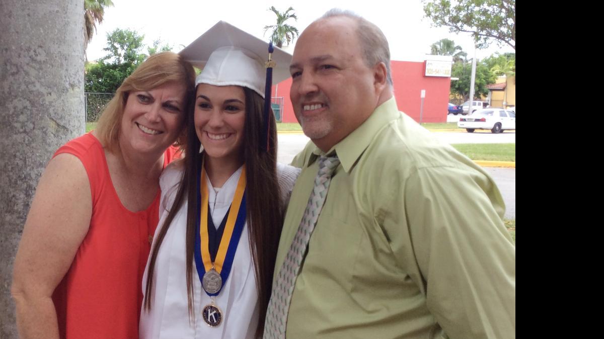 
High school graduate Nicole Santiago with her parents Kim and George Santiago outside Miami Dade County Auditorium.
