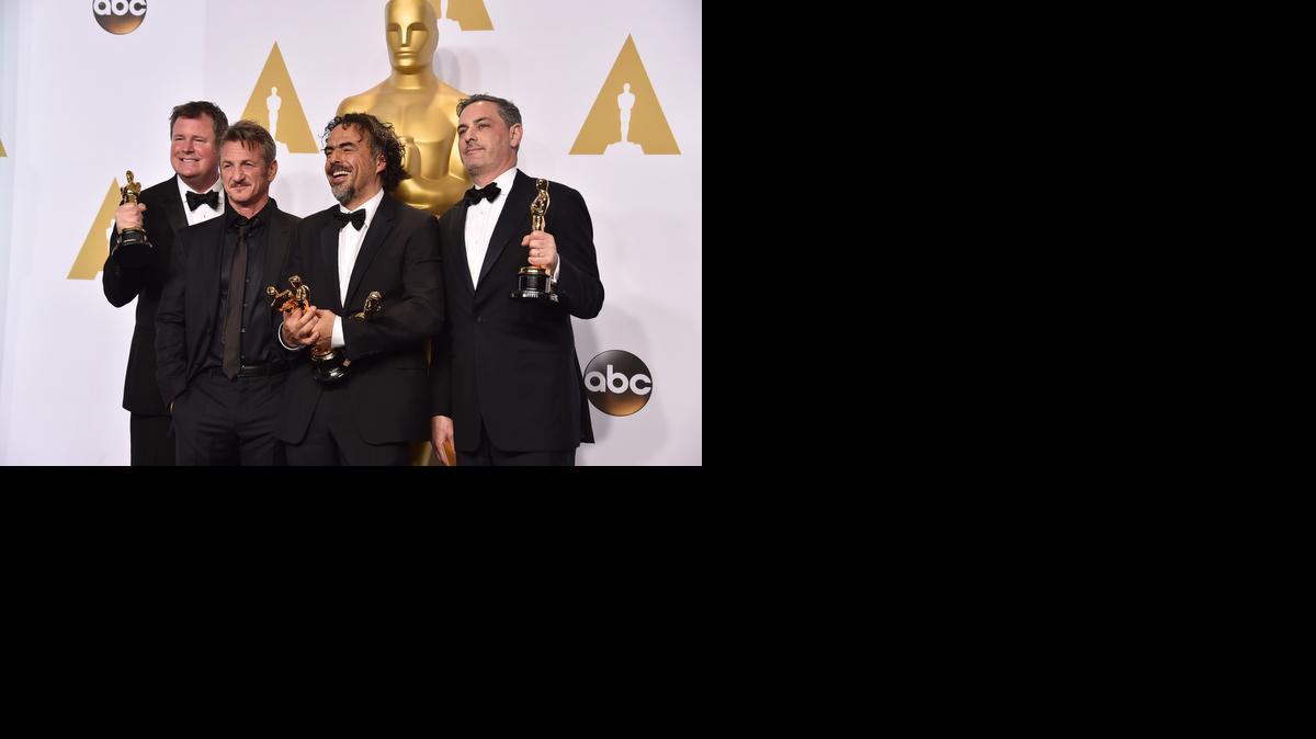 
James W. Skotchdopole, from left, Sean Penn, Alejandro González Iñárritu and John Lesher pose in the press room with the awards for best picture and best director for “Birdman” at the Oscars.
